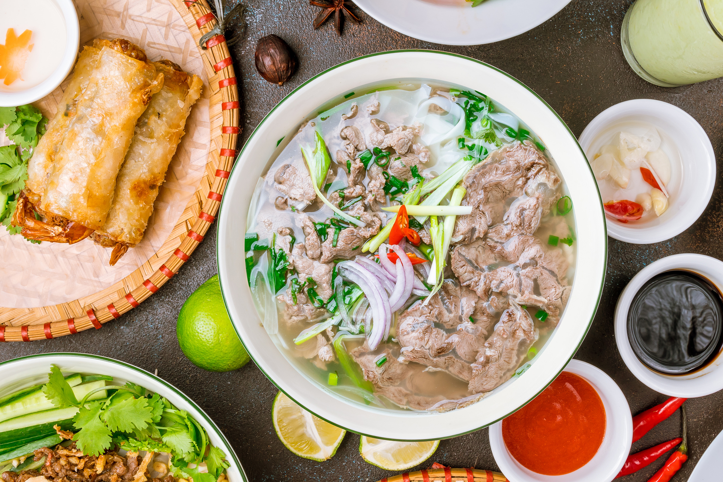 various bowls of Vietnamese food on a table