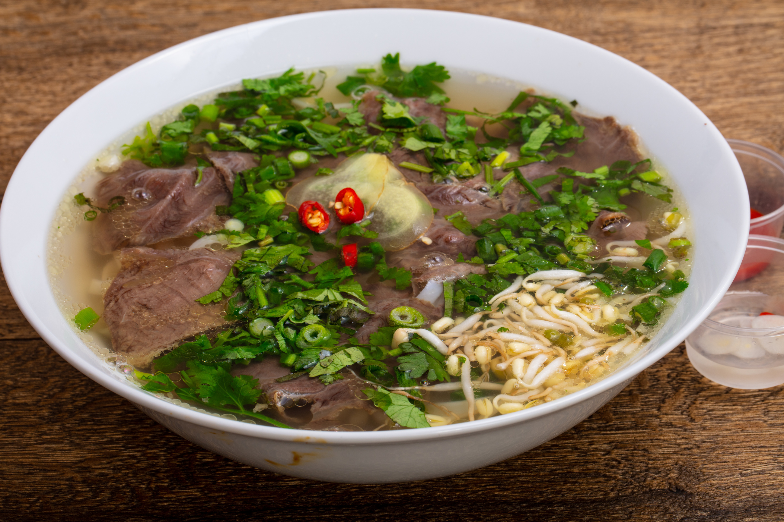 a bowl of soup with meat and vegetables in it