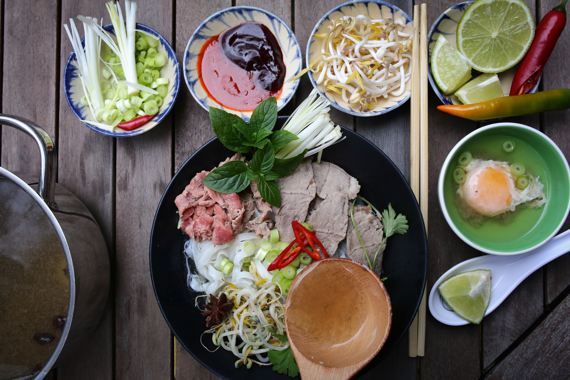 various bowls of food on a wooden table